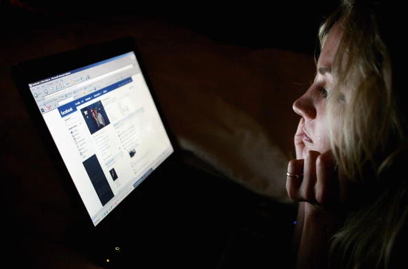 Girl browses the social networking site Facebook