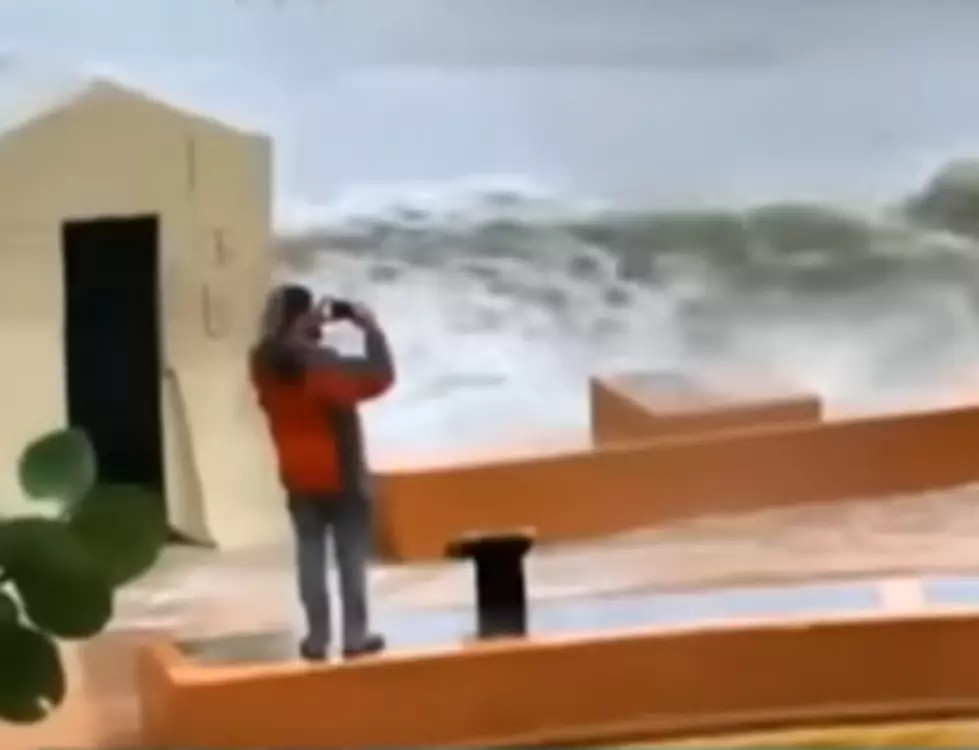 Man Taking Picture of Storm Gets Taken Out By Giant Wave