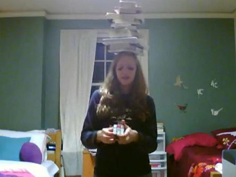 Girl Recites Pi While Solving Rubik’s Cube and Balancing Books on Head [VIDEO]