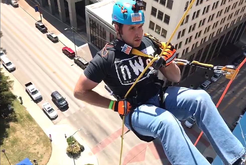 Eric the Intern Conquers His Fear of Heights While Rappelling Off of Big Blue [WATCH]