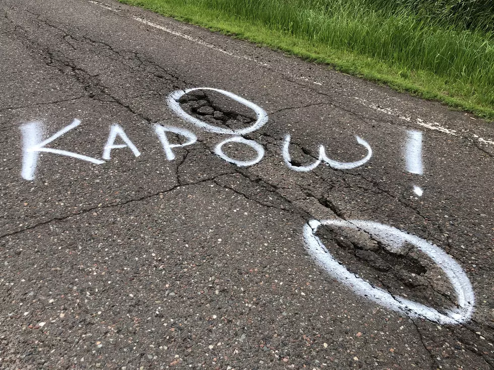 Hermantown Street Vigilante Marks Potholes In Road With Words Like ‘Yikes!’ And ‘Kapow!’ [PHOTOS]