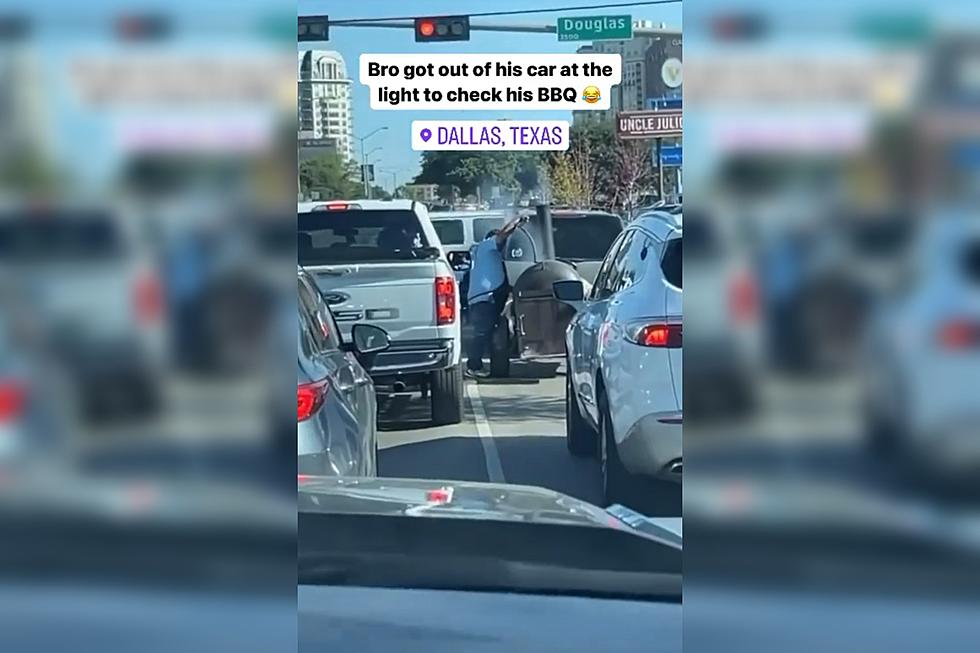 Man Checking BBQ Pit at Dallas Stoplight is Pure Texas