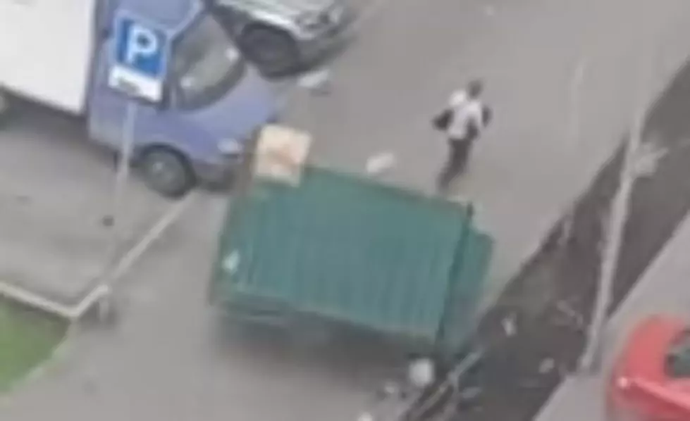 Lucky Guy Narrowly Escapes Getting Crushed By Flying Dumpster [VIDEO]