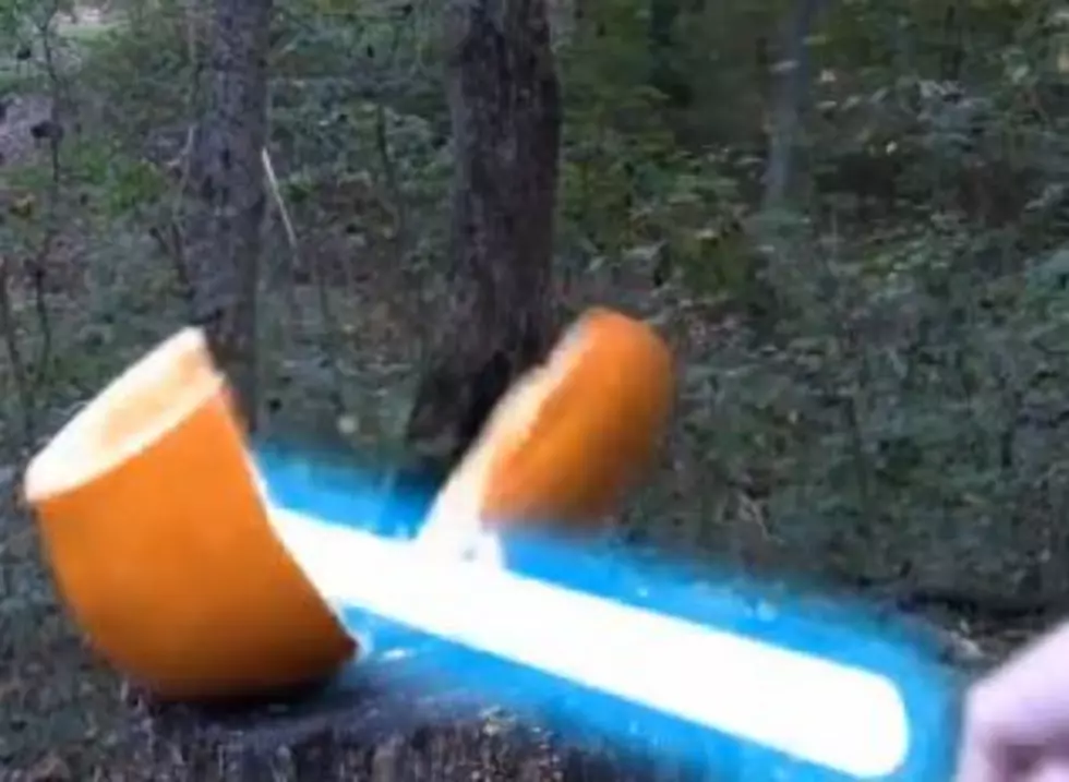 Watch a Guy Mutilate Pumpkins with Guns, Throwing Stars, a Weed Whacker and Even a Light Saber!