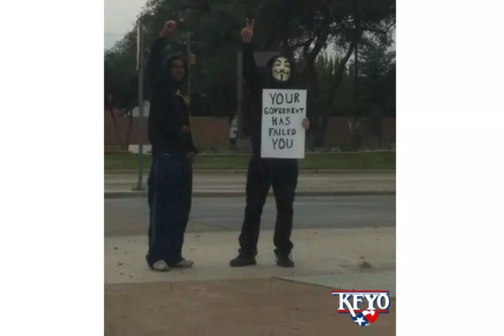 Guy Holds Hilariously Misspelled Sign During Lubbock ‘Million Mask March’ [Photo]