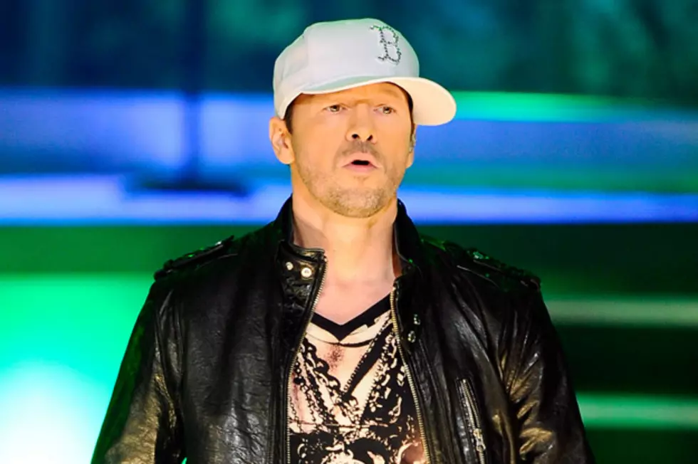 New Kid Fan Latches Onto Donnie Wahlberg During Concert