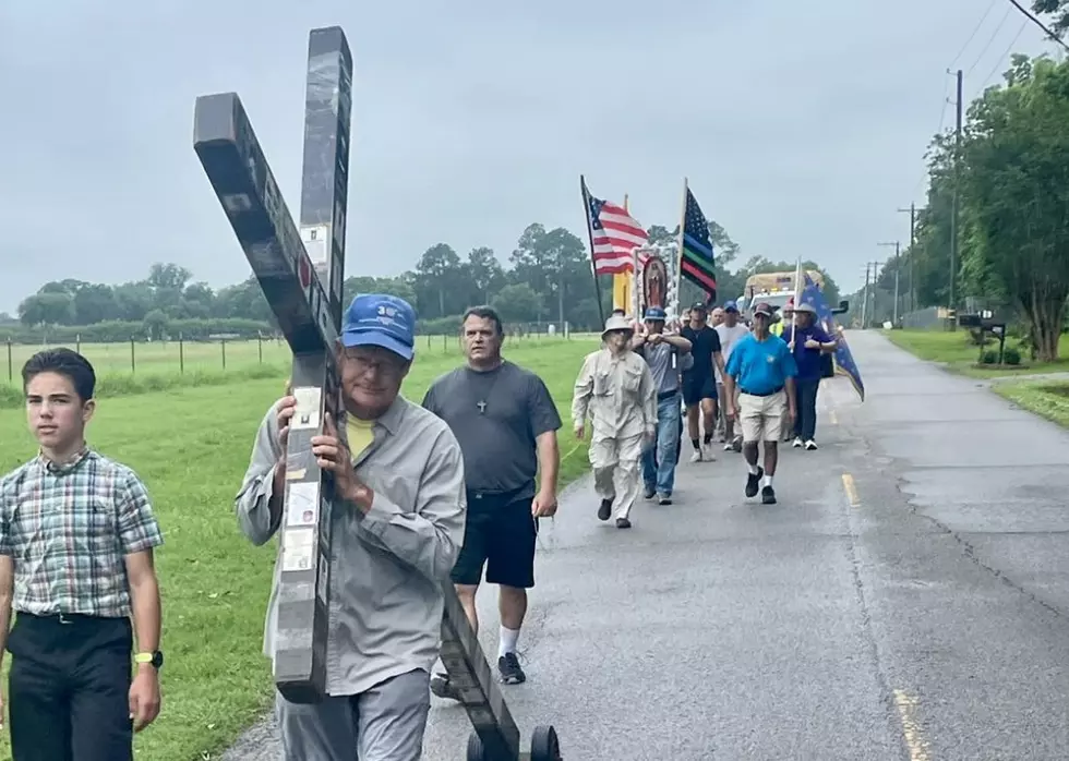 Men Journey Across Acadiana Carrying Flags and Crucifix