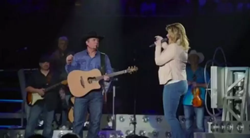 Trisha Yearwood Interrupts Garth Brooks To Deliver Some Great News During Concert [Video]
