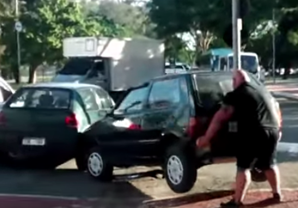 A Very Strong Man Lifts Car Off Of Bike Path [VIDEO]