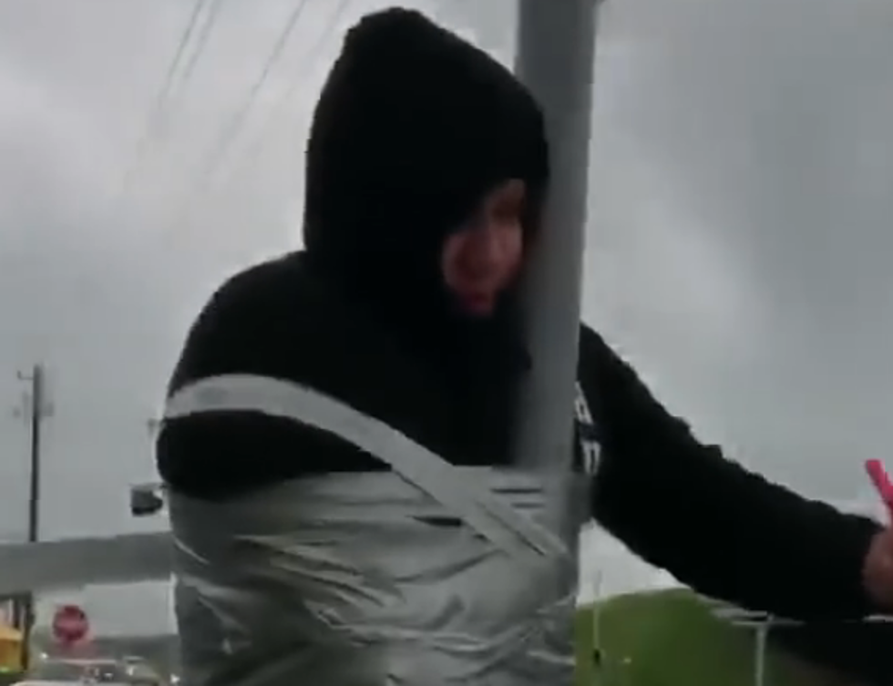 Police Respond To Man Taped To Street Sign Pole [VIDEO]