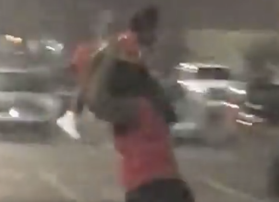 Woman Appears To Use Baby As Shield In Rainstorm [VIDEO]