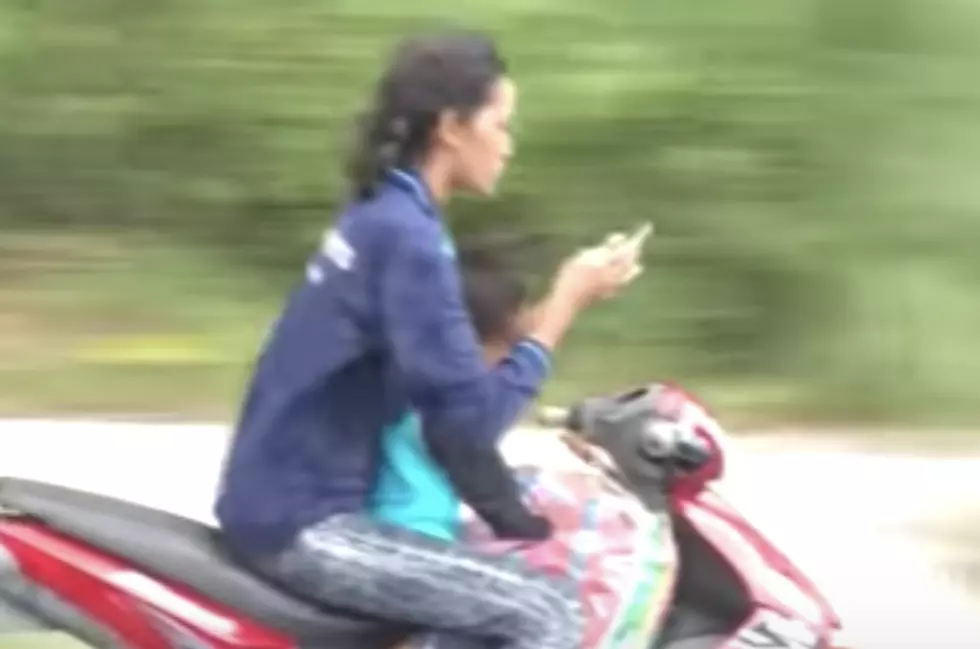 Woman Texting While Driving Scooter, Child On Lap [VIDEO]