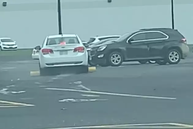 Woman Drives Over Parking Barrier In Parking Lot [VIDEO]