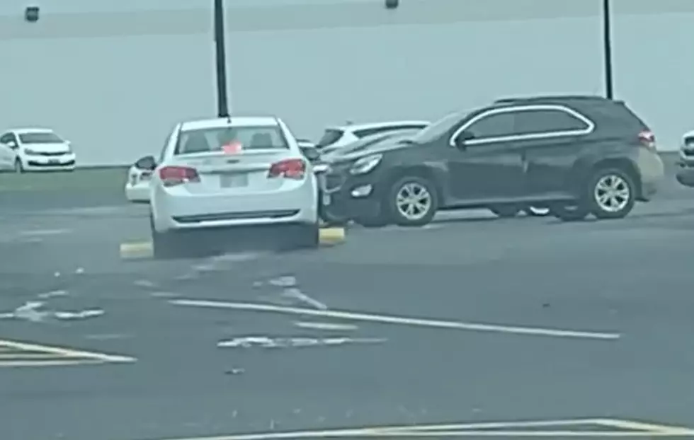 Woman Drives Over Parking Barrier In Parking Lot [VIDEO]