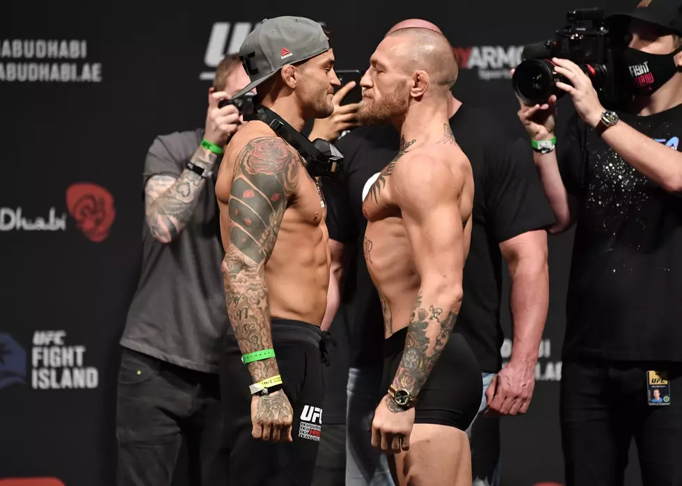 Watch Dustin Poirier Slip Conor McGregor A Bottle Of His Signature Hot Sauce Ahead Of Their UFC 257 Match