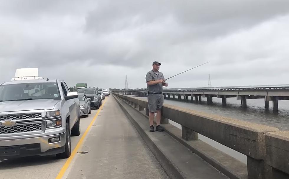 Man Fishes Off I-10 Bonnet Carré Spillway Bridge While Traffic at a Standstill