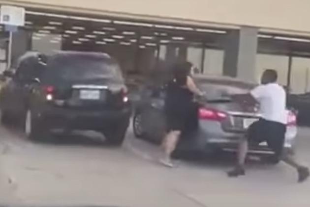 Driver Hits Building Then Hits Person and Other Cars in Parking Lot [VIDEO]