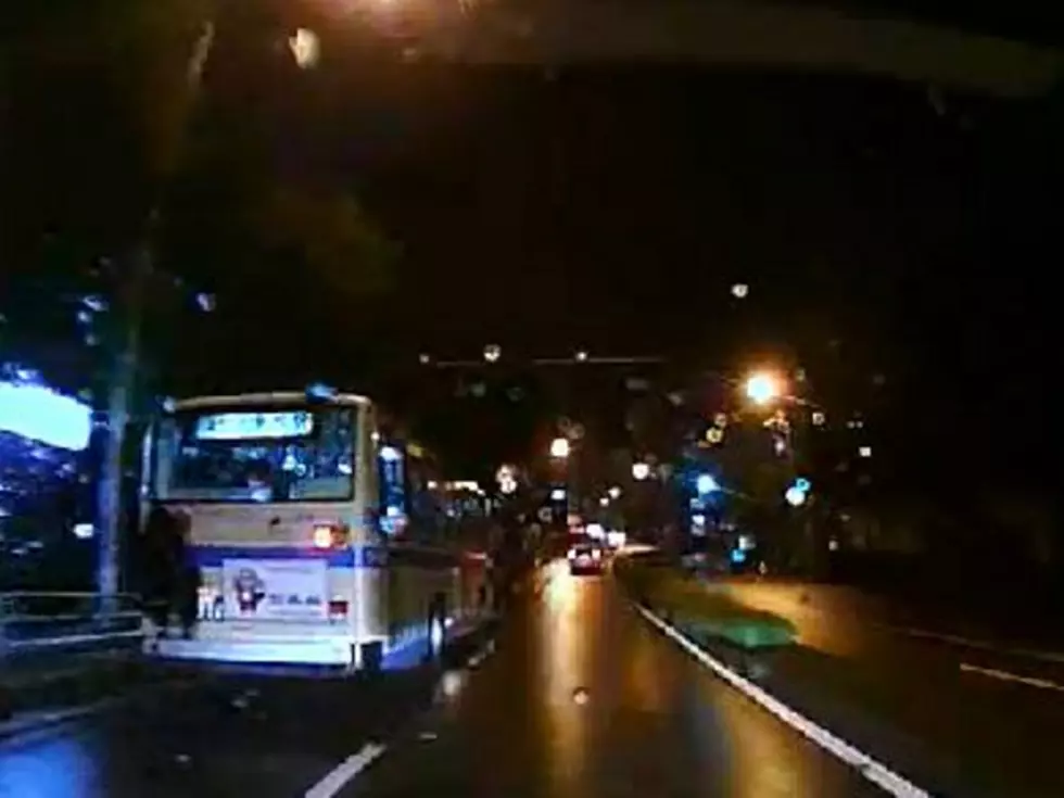 Cheapskate Catches Ride on Back of Bus [VIDEO]