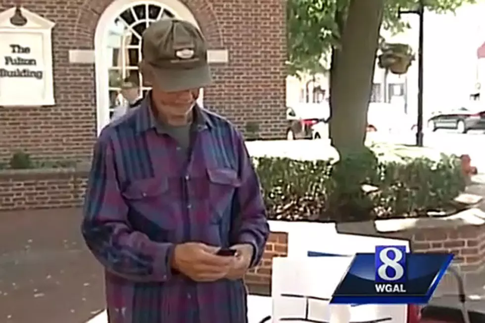 Panhandler Stops Interview to Answer Cell Phone