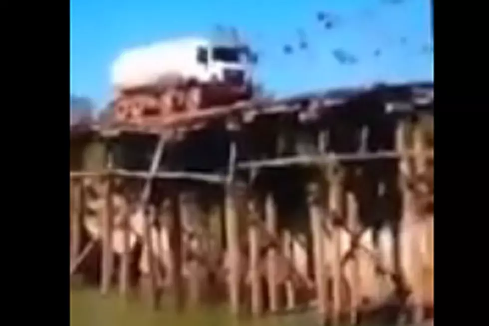Giant Truck Driving Over Rickety Wooden Bridge Ends About As Badly As You’d Expect