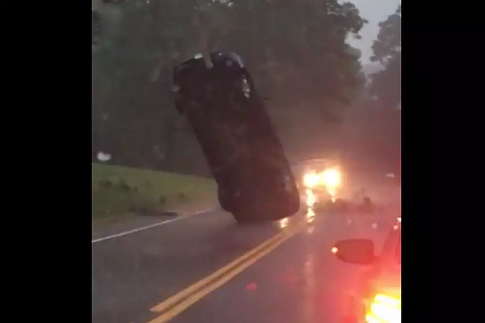 Car Gets Tangled in Power Lines. Stands Upright. In a Rain Storm.