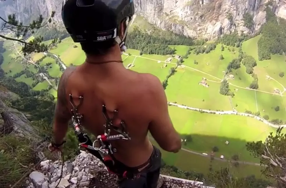 Guy Goes BASE Jumping – Parachute Attached To Back Piercings [Video]