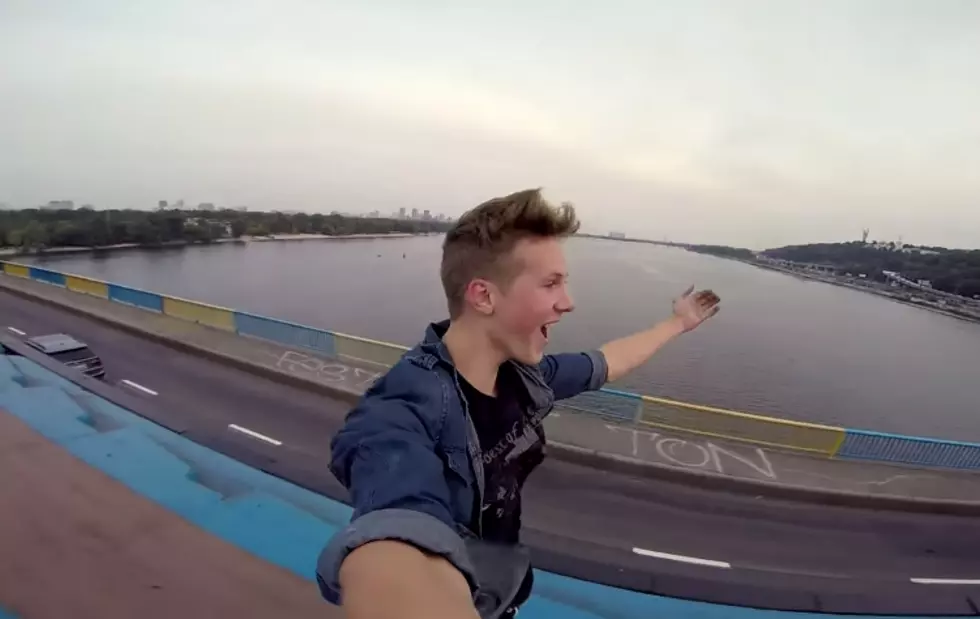 Crazy Kid Surfs On Top Of A Moving Train And Films It [Video]