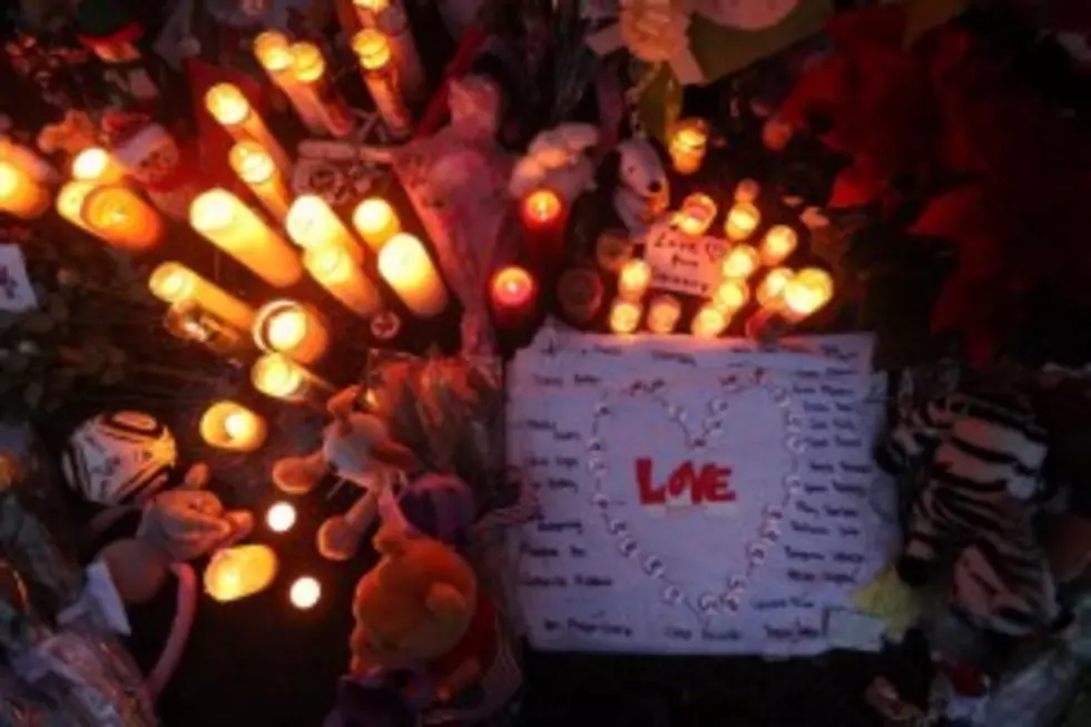 Candles are lit among mementos at a memorial for victims of the mass shooting at Sandy Hook Elementary School,