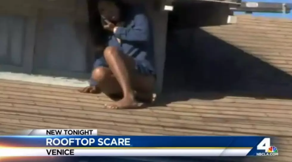 WATCH: Woman seen on roof hiding from intruder