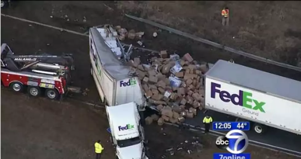 FedEx truck overturns on highway, spills packages