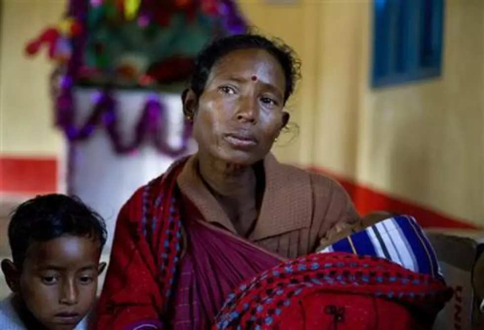 Survivors huddle after violence in India kills 72