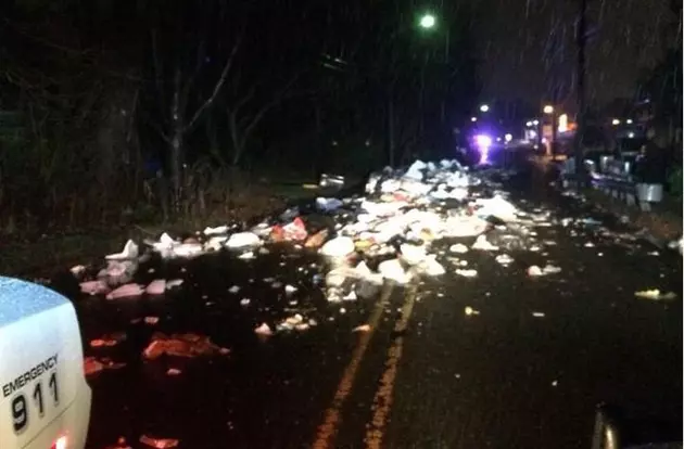 A traffic mess? Garbage truck dumps all over street, closing road for hours