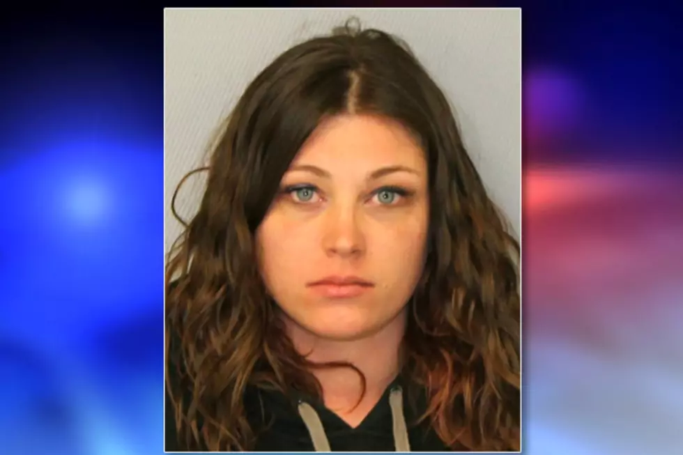 Woman spat at, kicked EMS worker who was just trying to help, cops say