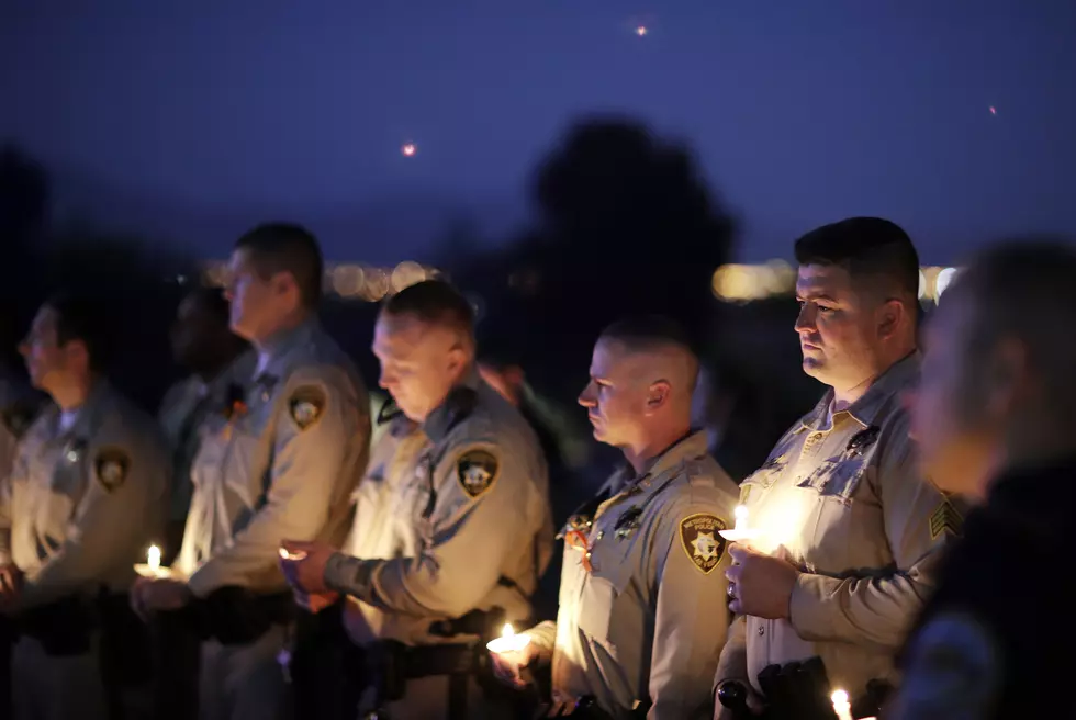Thousands mourn slain officer as Las Vegas probe continues