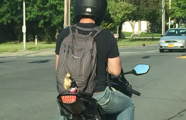 Why Does This Man Have a Barbie Strapped to the Back of His Motorcycle?