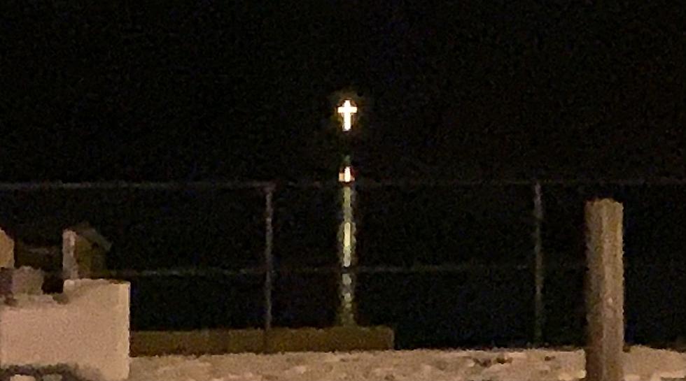 What is the story of the cross on the lake?