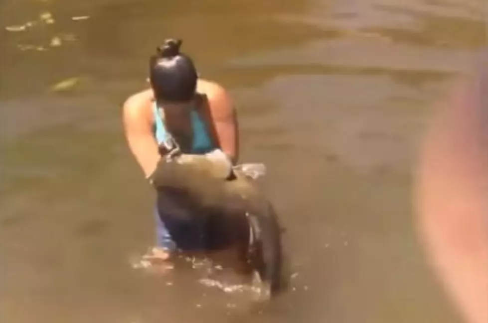 Watch a Girl Catch a Huge Catfish With Her Bare Hands