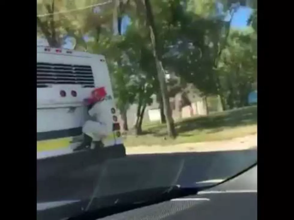 Creepy Clown Hitches a Ride on Back of Detroit Bus [VIDEO]