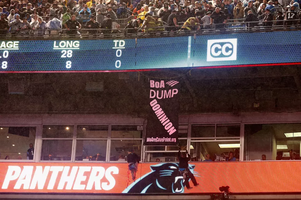 Bank of America Protesters Rappel Down, Hang From Upper Balcony During Panthers-Colts Game
