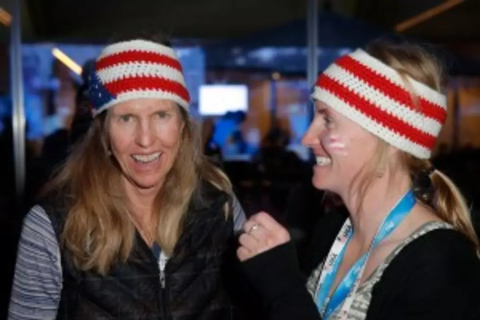 Fans wearing USA hats watch the Winter Olympics last week at USA House in the Olympic Village in Sochi, Russia. (Photo: Joe Scarnici/Getty Images for USOC)