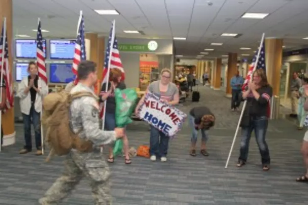 Deann Oliver clutches herself as her son, U.S. Army Spec. Mitchell Oliver, surprisingly arrived Saturday at Gerald R. Ford International Airport. (Photo: Rick Martinez/98.7 WFGR)