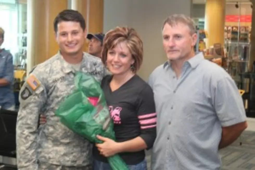U.S. Army Spec. Mitchell Oliver smiles for a photo with his parents, Deann and Gary Oliver, of Greenville, on Saturday at Gerald R. Ford International Airport in Grand Rapids on Saturday. (Photo: Rick Martinez/98.7 WFGR)