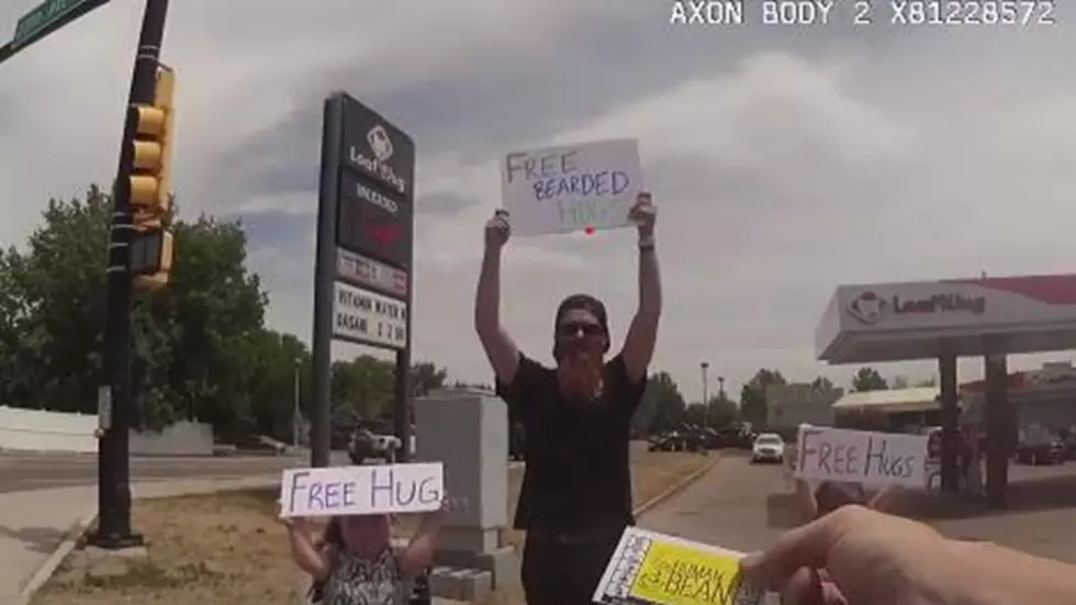 Dad and Daughters Give Out Free Hugs in Evans, Cop Gets Two