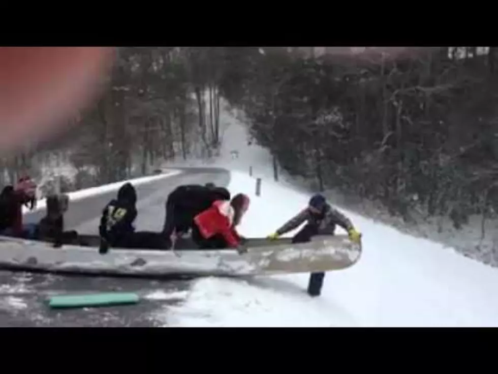 Watch a Filled Canoe Slide Down a Hill into Lake