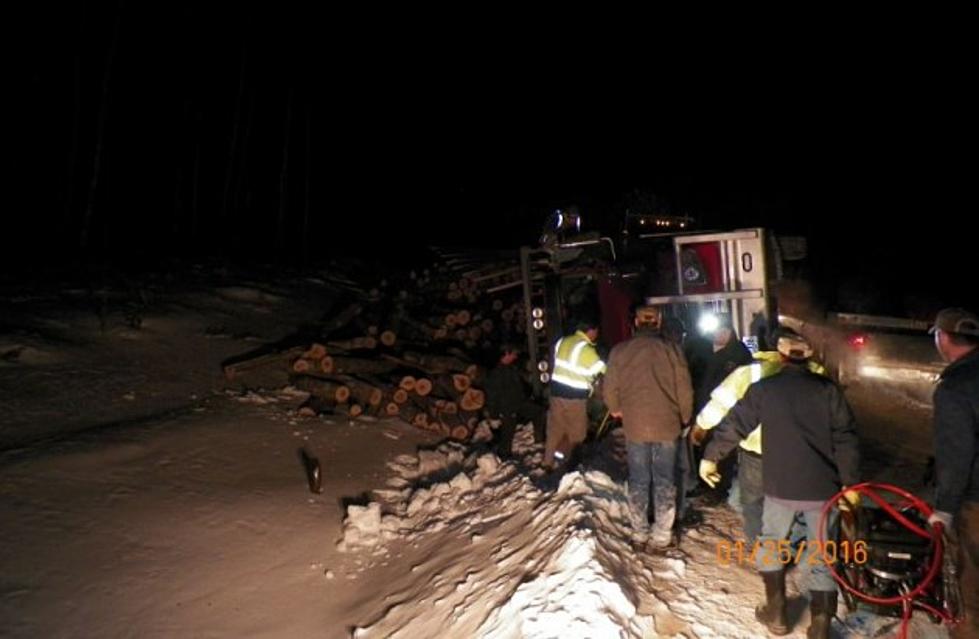 Driver Injured When Truck Rolls Onto Its Side And Spills Tree-Size Logs
