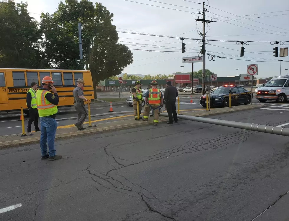 Utility Pole Knocked Down, Strikes Vehicle on Front Street