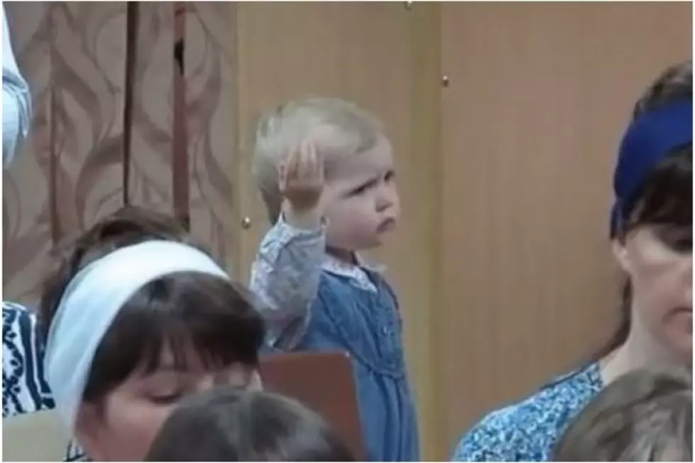 Watch as This Cute Little Girl Secretly Performs Behind Singing Grownups
