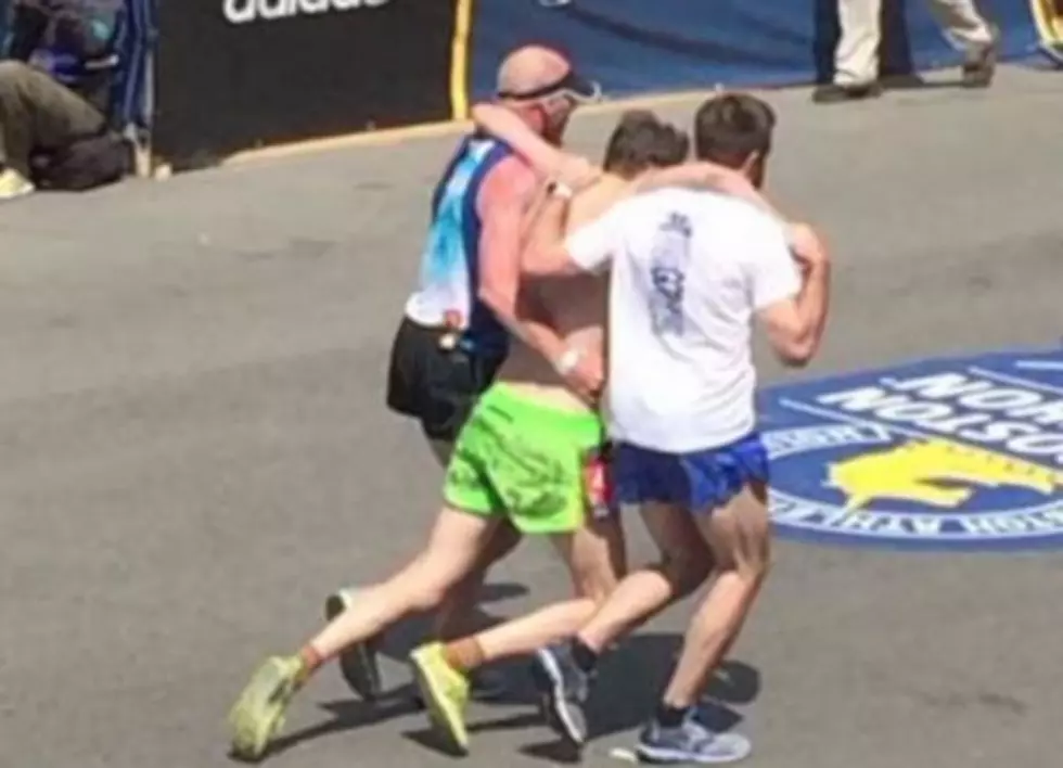 Boston Marathon Runners Help One Cross The Finish Line!