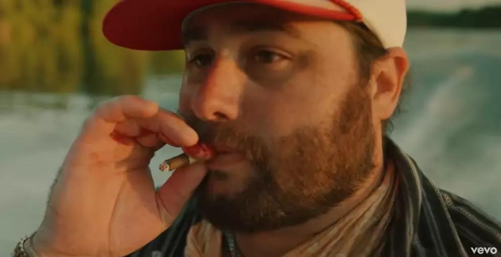 Koe Dumps Body in a Lake While Smoking a Black & Mild in New ‘Sundy or Mundy’ Video