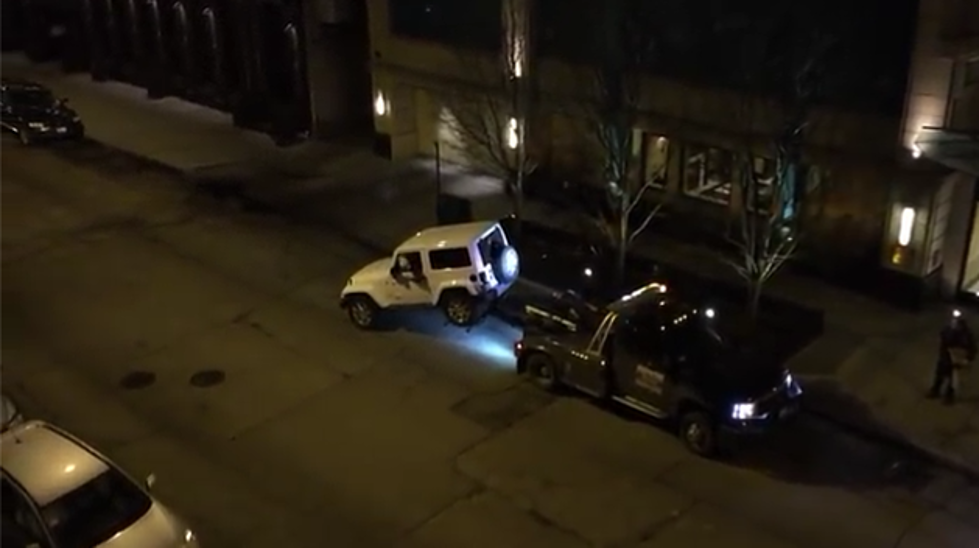 Jeep Breaks Free From the Evil Claw of a Tow Truck